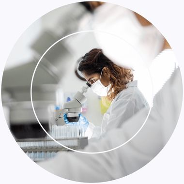 Illustrative image: scientist using a microscope