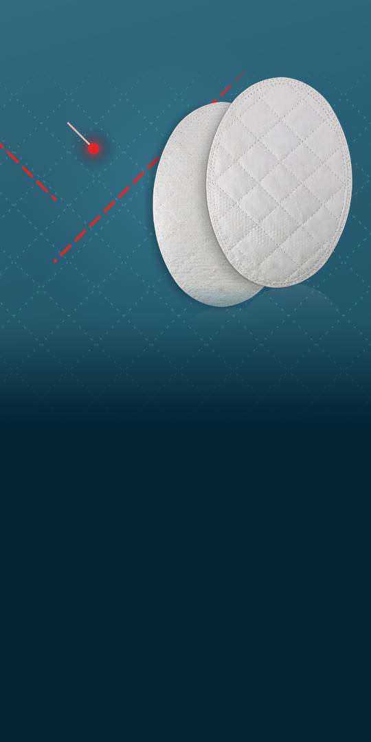 Two oval pads of reinforced tissue matrix, one quilted with a diamond pattern of dotted stitches, on a teal field