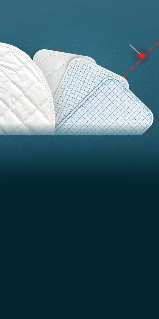 Pads of reinforced tissue matrix, quilted and grid-stitched, at the edge of a teal field